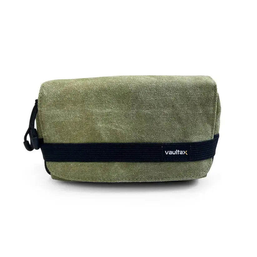 An olive green canvas pouch with a black elastic band featuring the white 'Vaultlax' logo, shown on a plain white background.